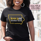 Person wearing a black t-shirt with 'iowant another book' design in Iowa Hawkeys colors, standing outdoors.