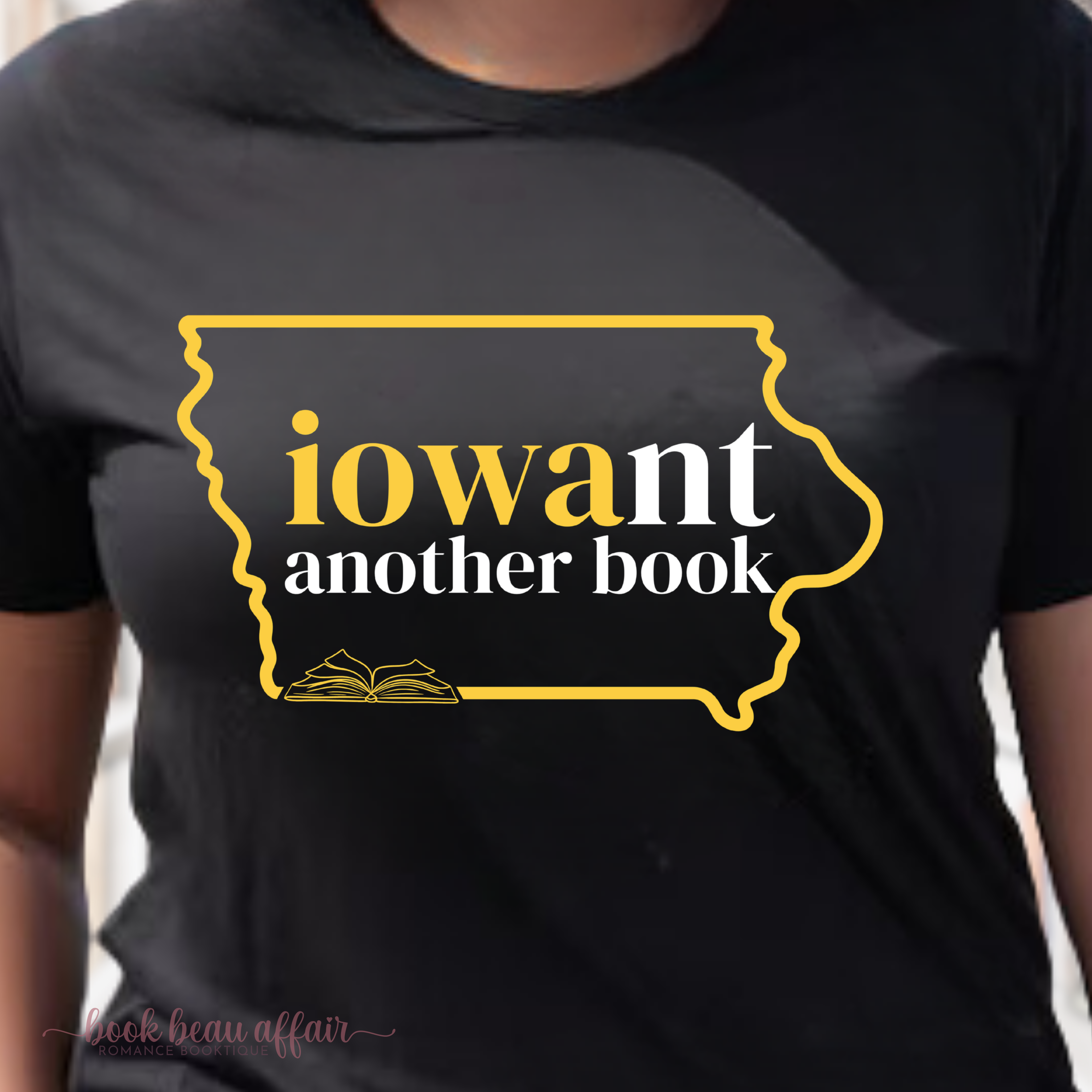 Close up of Black t-shirt with yellow and white text that says Iowant another book and graphic of the state of Iowa outline.