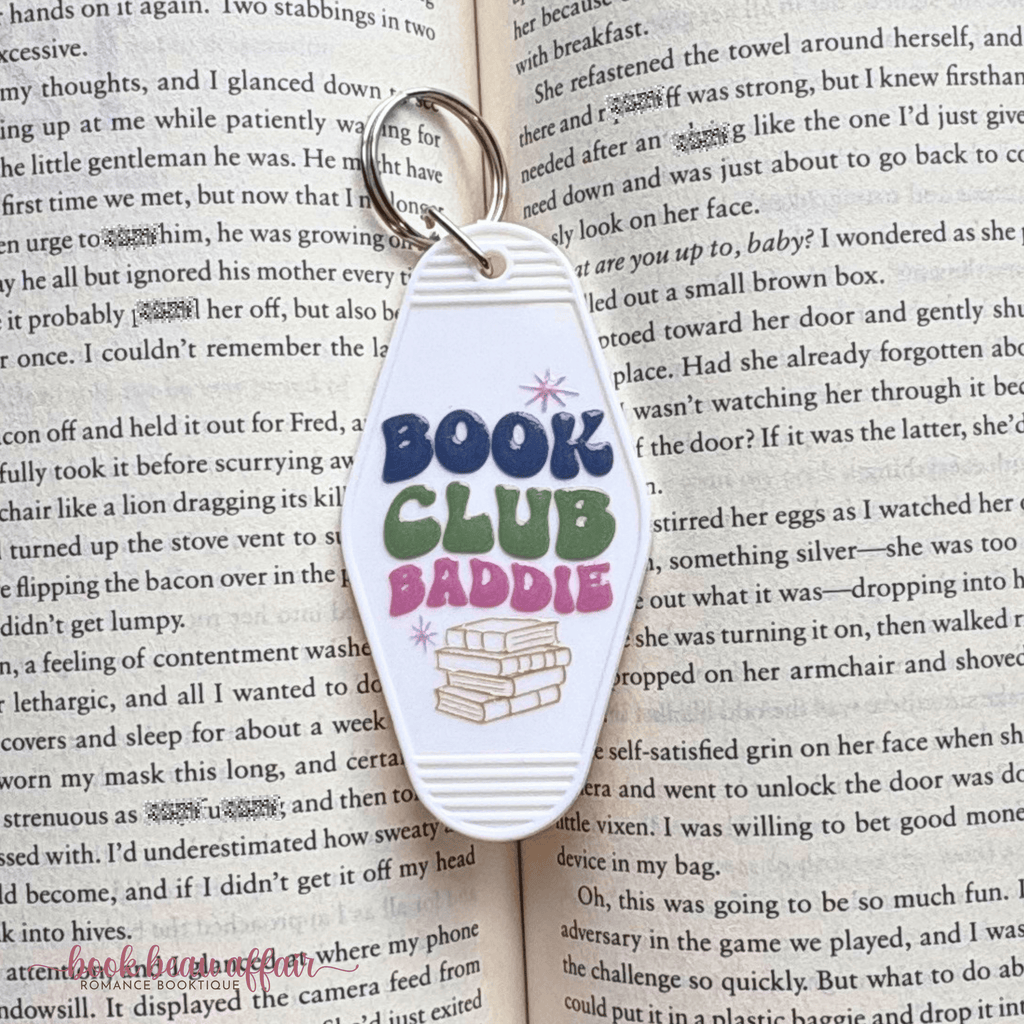Keychain with 'Book Club Baddie' text on an open book