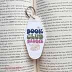Keychain with 'Book Club Baddie' text on an open book