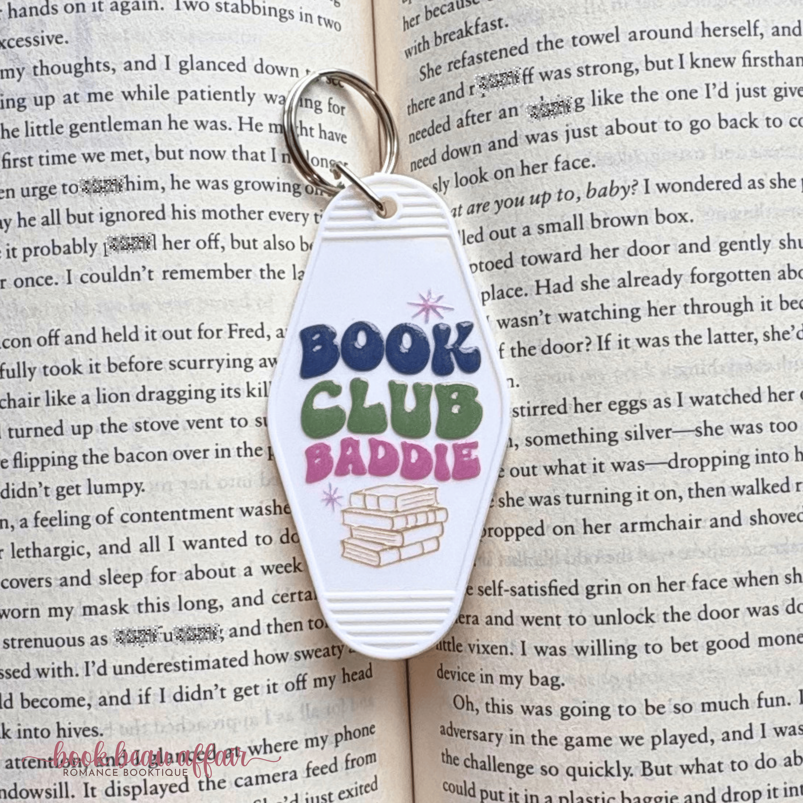 Keychain with 'Book Club Baddie' text on an open book