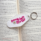 Keychain with 'bookish girl' design on an open book