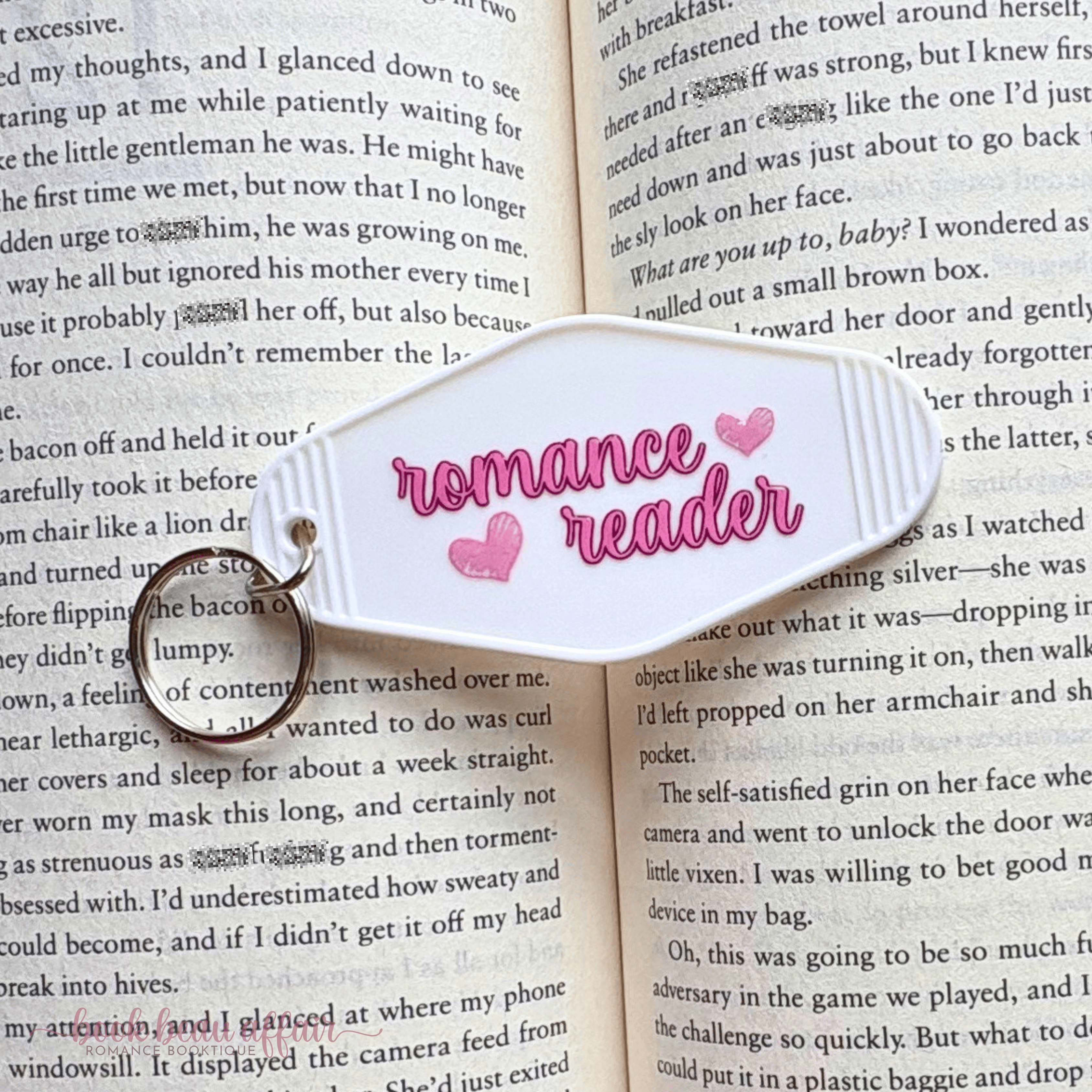 Book with a 'romance reader' marker on an open book