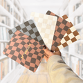 A group of checkered kindle case inserts