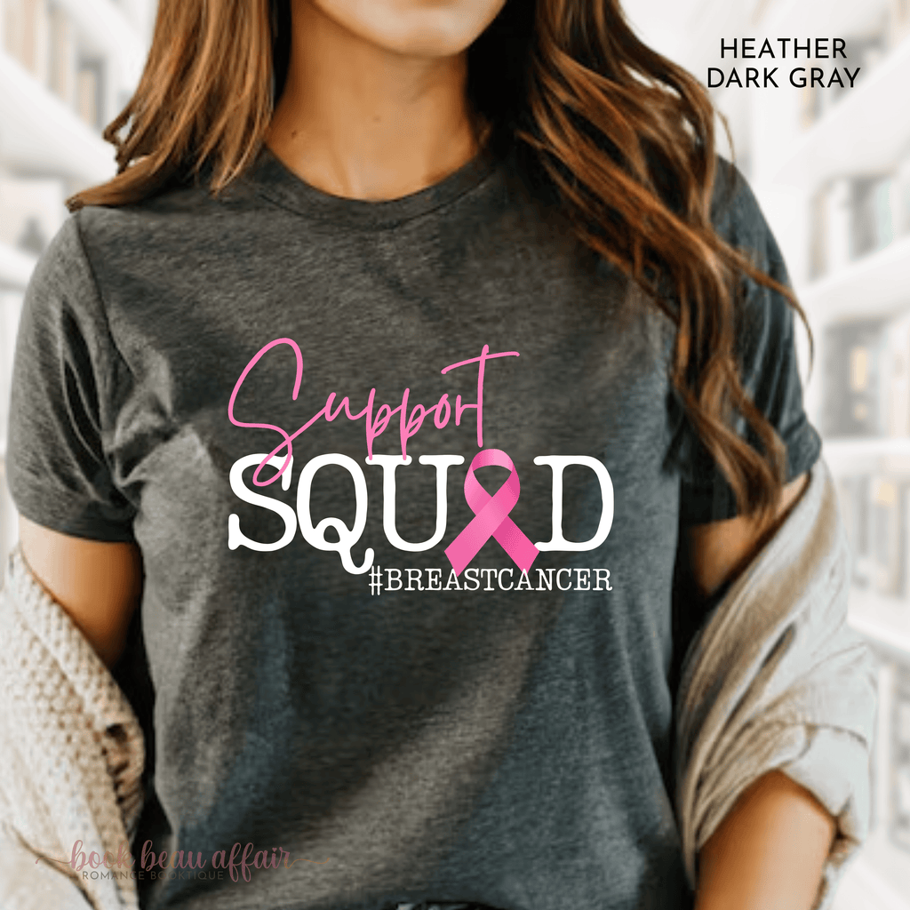 Person wearing a dark gray t-shirt with 'Support Squad #BreastCancer' text and pink ribbon design.