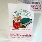 Magnetic bookmark with 'I Like My Cocoa Books Hot' design on a stand.