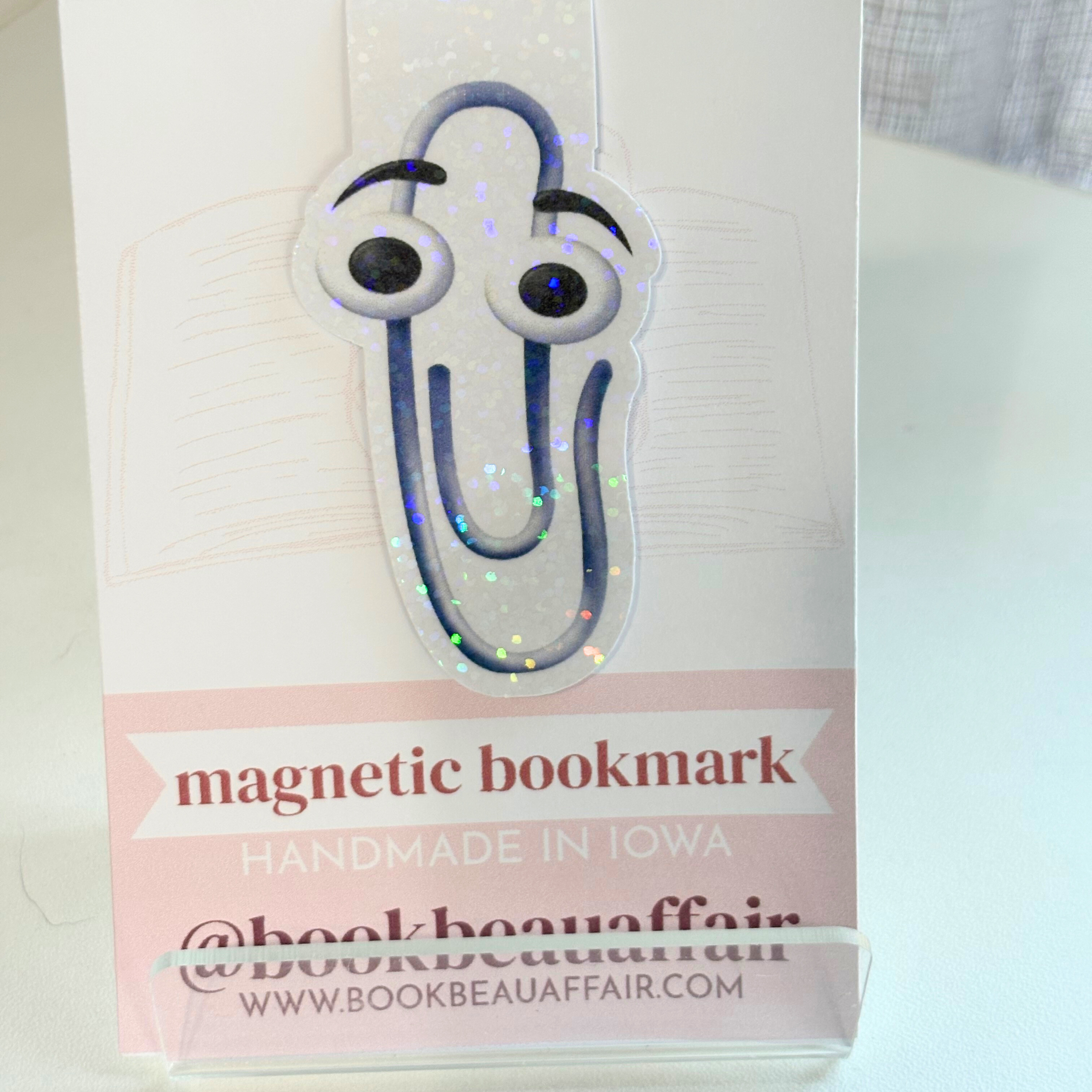 Magnetic bookmark with paper clip that has googly eyes on a white background