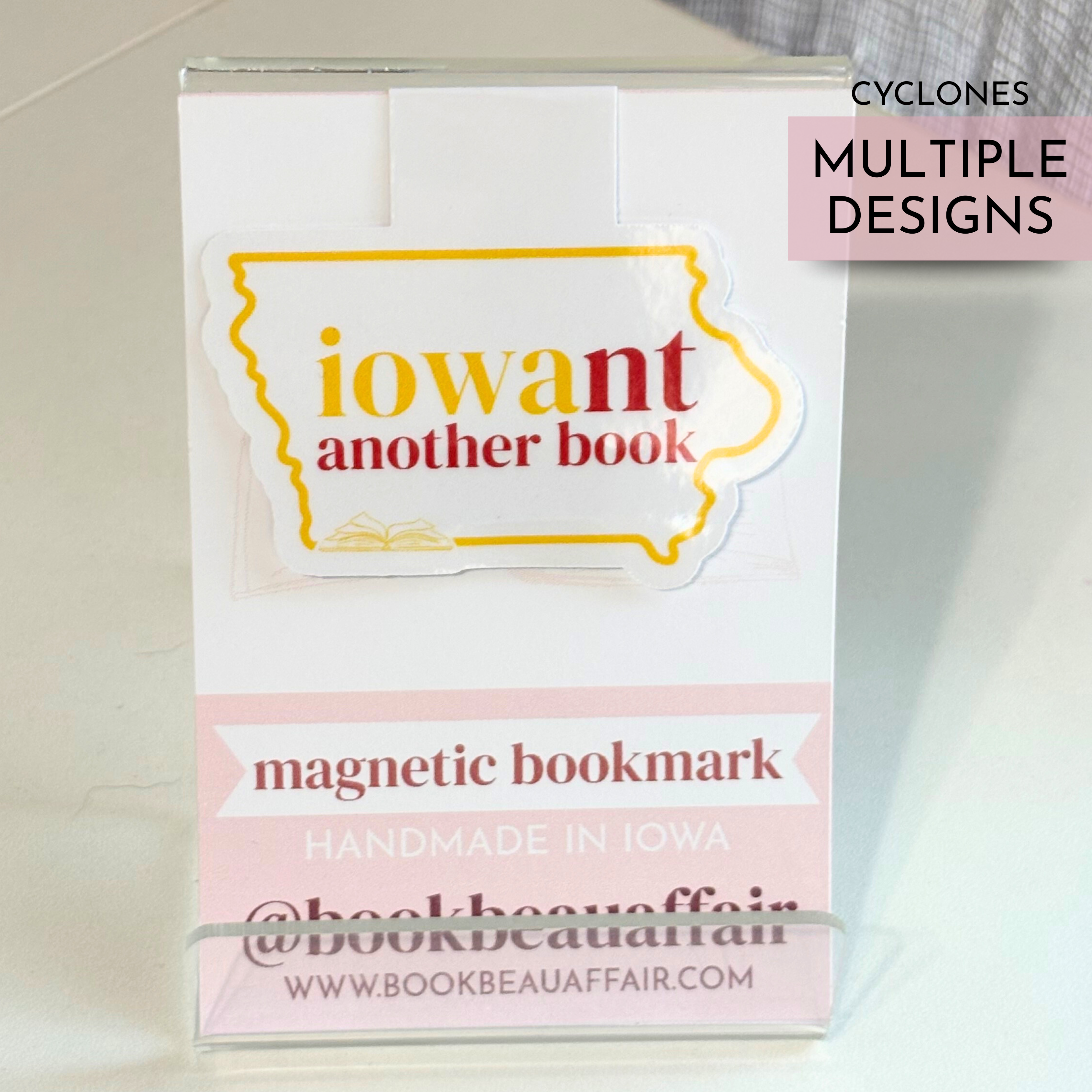 Magnetic bookmark with 'iowant another book' design on a white background and yellow and red text for Iowa State University
