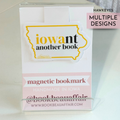 Magnetic bookmark with 'iowant another book' design on a white background and yellow and black text for University of Iowa