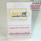 Magnetic bookmark with 'iowant another book' design on a white background and yellow and black text for University of Iowa