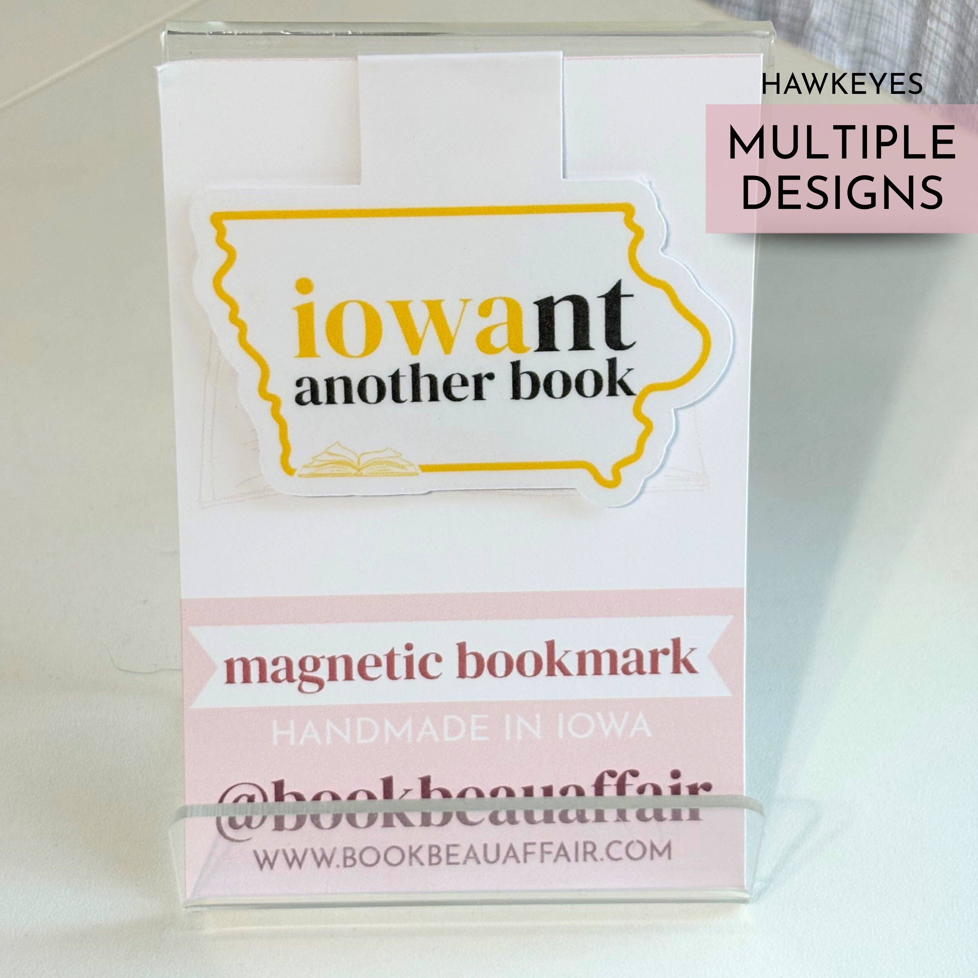 Magnetic bookmark with 'iowant another book' design on a white background and yellow and black text for University of Iowa
