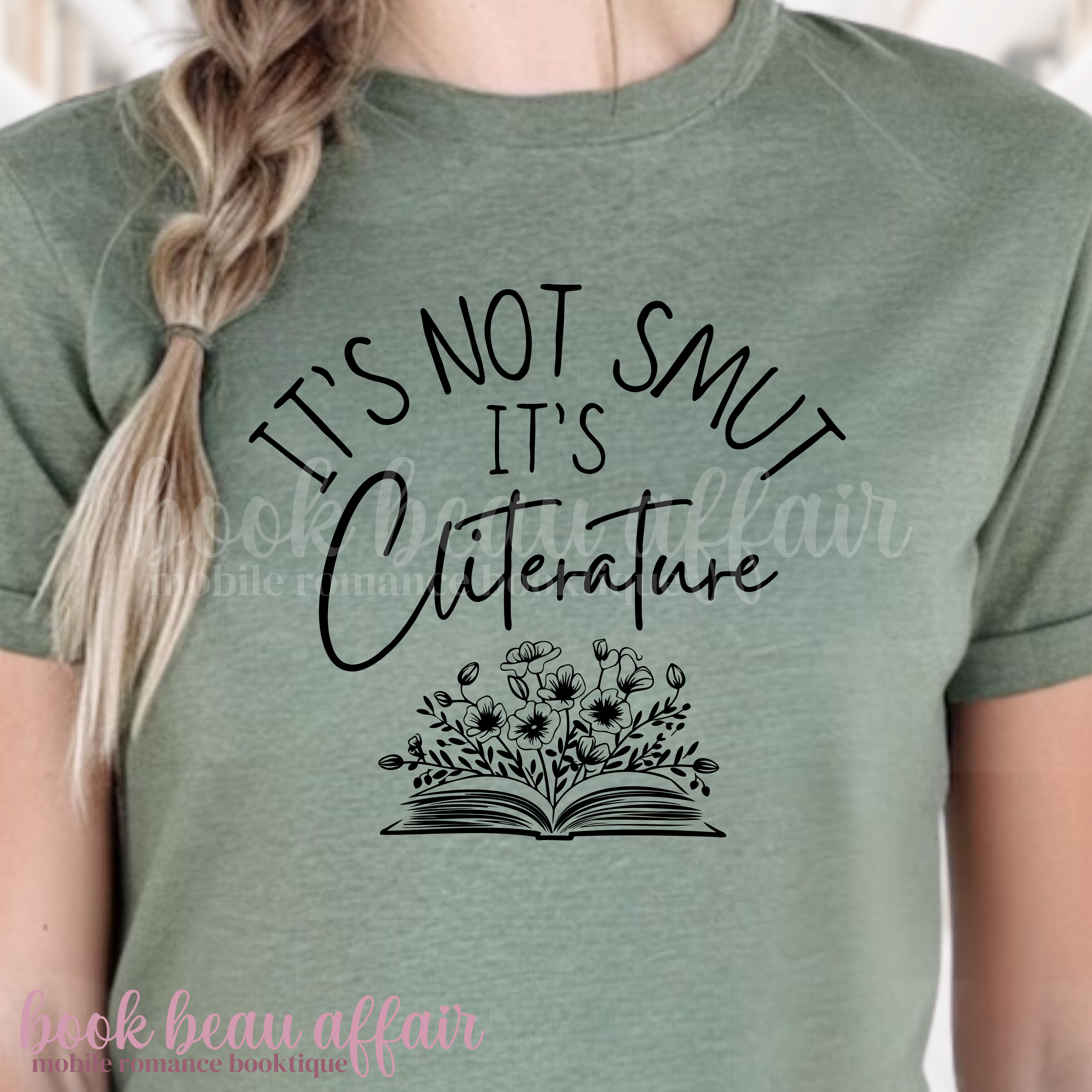 Person wearing a green t-shirt with 'It's Not Smut, It's Cliterature' text and book graphic.