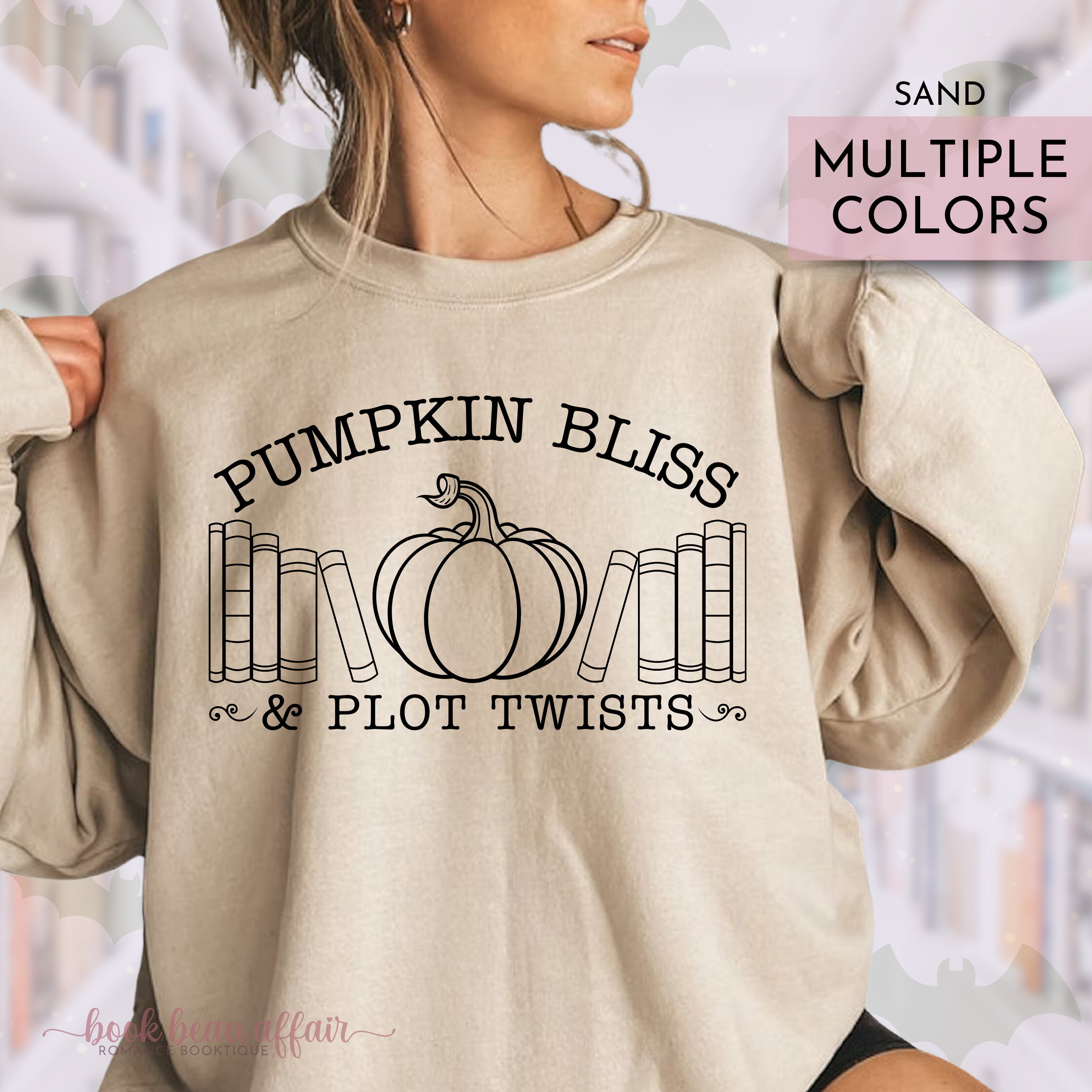 Beige sweatshirt with 'Pumpkin Bliss & Plot Twists' text and pumpkin graphic, worn by a person.