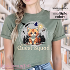 t-shirt with dragons and an orange tabby cat that says "Broccoli's Quest Squad"