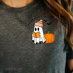 Gray t-shirt with a ghost reading a book, pumpkin, and text 'read more boooks' on a dark background.