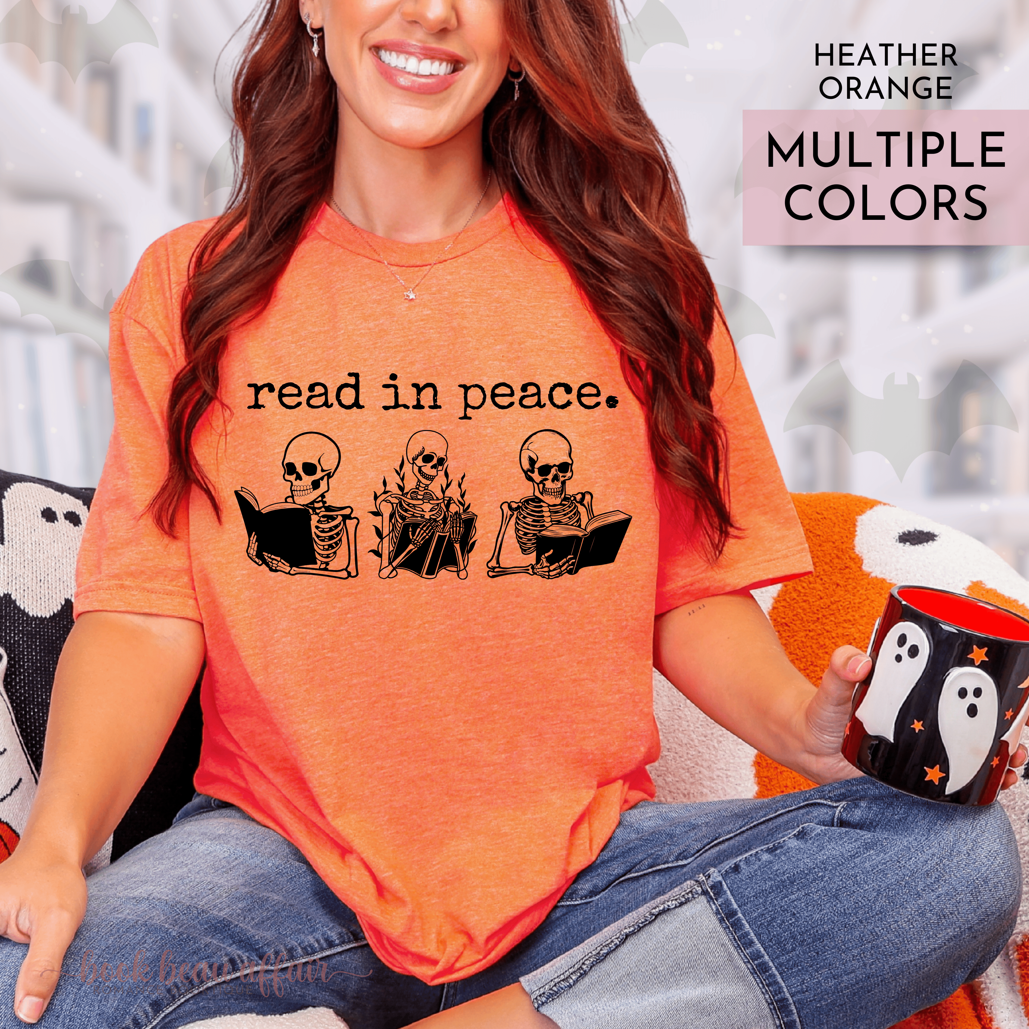 Person wearing an orange t-shirt with skeleton graphics and text read in peace, holding a mug with ghost design.