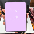 Kindle case insert with a purple background displaying a heart and snowflake icon 