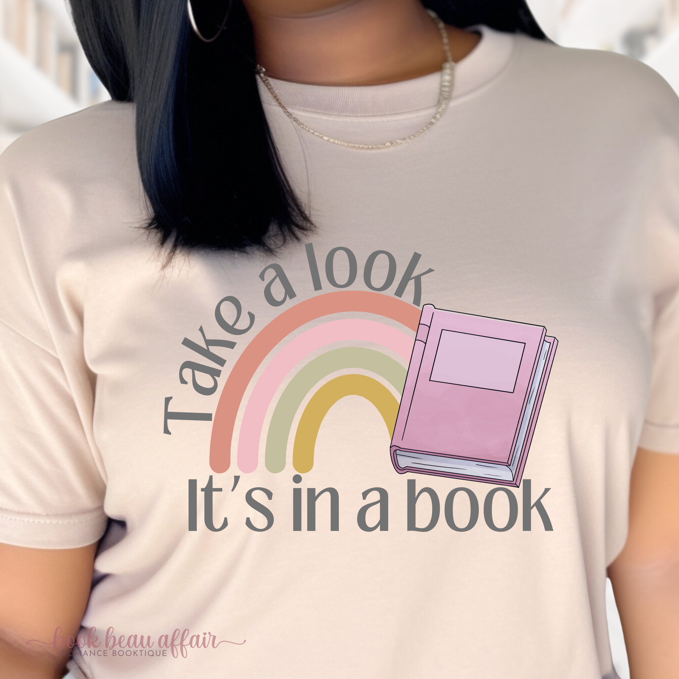 CLOSE UP OF Take a Look. It's in a Book. Reading Rainbow. Bookish shirt. TAN SAND TEE