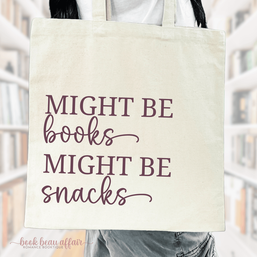 Close up of a tote bag that says "Might be books, Might be snacks"