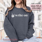 Person wearing a dark heather sweatshirt with 'write on' text and rock on hand gesture design.